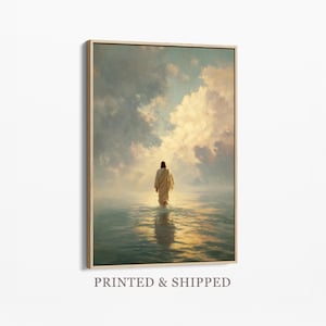 May include: A framed art print depicts a figure in a flowing robe walking in water towards a bright sky filled with clouds. The artwork has a soft, ethereal quality with warm, golden light reflecting on the water's surface. The text "PRINTED & SHIPPED" is at the bottom.