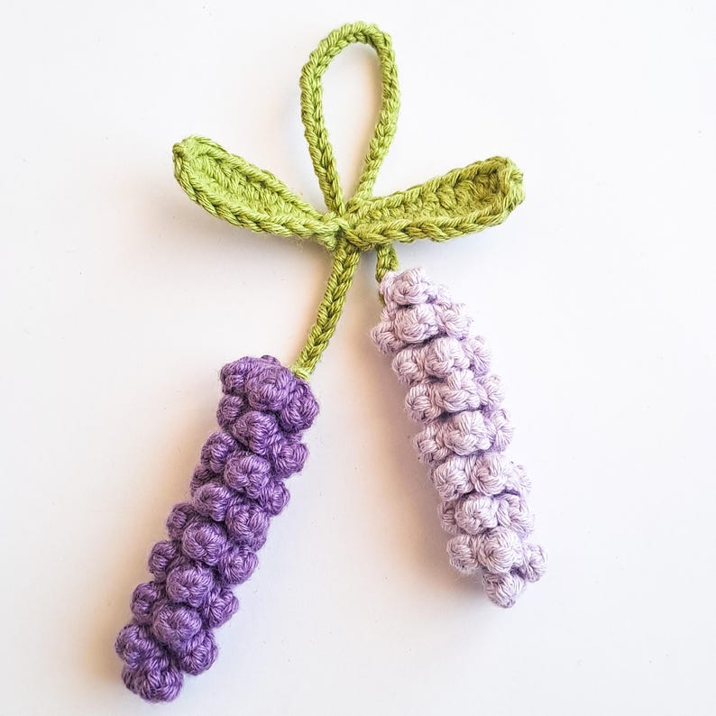 Crochet lavender keychain pattern with two purple lavender stems and a green leaf loop for hanging.