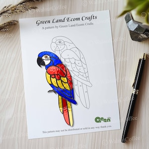 May include: A printable pattern for a stained glass craft project featuring a colorful macaw. The pattern includes numbered sections for each color of glass needed. The text "Green Land Ecom Crafts" and "A pattern by Green Land Ecom Crafts" is printed at the top of the page.