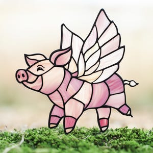 May include: A stained glass pig with pink and white wings. The pig is standing on a bed of green moss.
