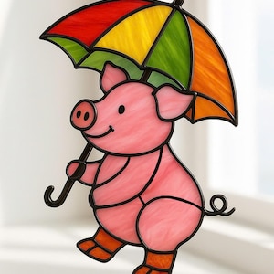 May include: A stained glass pig figurine holding a rainbow umbrella. The pig is pink with orange boots and a curly tail. The umbrella has red, orange, yellow, and green panels. The figurine is outlined in black and hangs from a chain.