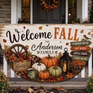 May include: A semi-circular banner with a white wood-plank background featuring the text Welcome FALL and The Anderson FAMILY. It displays a wooden wagon wheel, pumpkins, a lantern, a mug labeled Hello Pumpkin, and signs for Pumpkin Patch.
