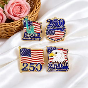 May include: Four patriotic pins celebrating the 250th anniversary. Designs include the Statue of Liberty, an American flag, and an eagle, all with red, white, and blue colors. The pins are gold-toned with enamel details.