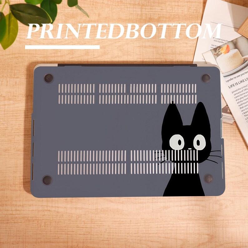 May include: A gray laptop case featuring a black cat graphic on the bottom. The case has ventilation slots and the text "PRINTEDBOTTOM" at the top. The cat has large white eyes and a simple, stylized design.