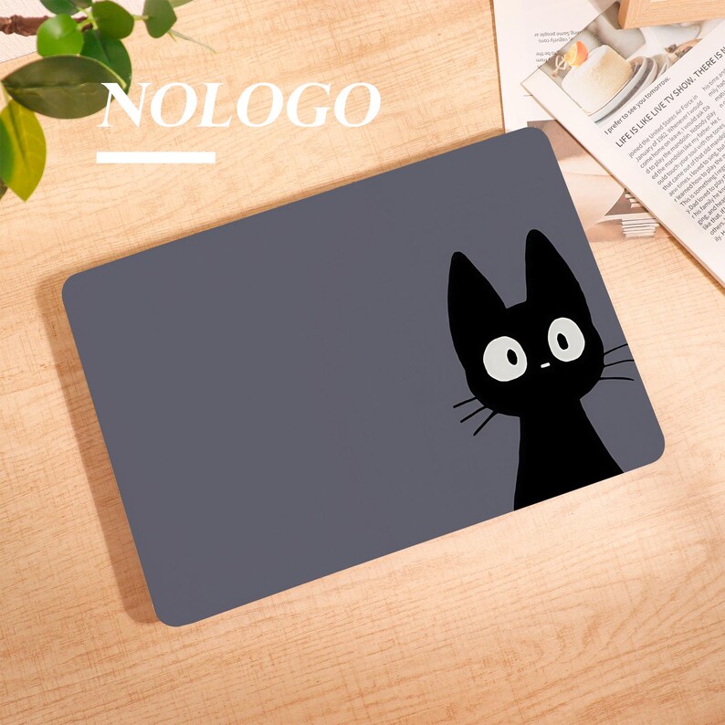May include: A rectangular, gray mousepad featuring a black cat cartoon with large white eyes and whiskers. The word "NOLOGO" is printed in white at the top left. The mousepad is on a wooden surface.