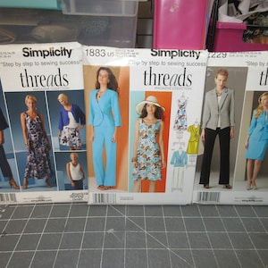 May include: Three Simplicity Threads magazine sewing patterns featuring different clothing designs. The patterns are for sizes 6-16 and feature a variety of styles, including a blazer, a dress, and a skirt.