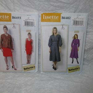 May include: Two sewing pattern packets, Lisette brand, featuring illustrations of dresses and jackets. One packet is labeled B6493, the other B6482. Both packets have the Butterick logo.