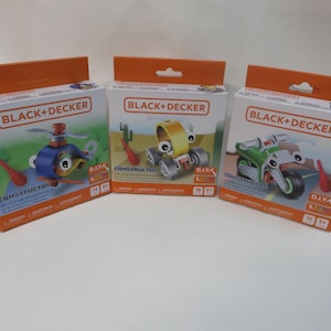 May include: Three orange boxes with black and yellow text that reads "BLACK+DECKER CONSTRUCTOR D.I.Y.K."  Each box features a different toy construction project: a helicopter, a truck, and a motorcycle.