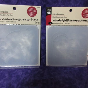 May include: Two packages of clear plastic patch templates for crafting. The package on the left has 10 templates with various shapes, including a dinosaur, a heart, a star, and a car. The package on the right has 13 templates with the alphabet. Both packages are labeled "Dritz Patch Templates".
