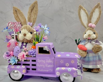 May include: A purple toy truck with a bunny and Easter eggs in the bed. The truck has a sign that says "Spring Valley Bunny Ranch Bluebonnet TX".