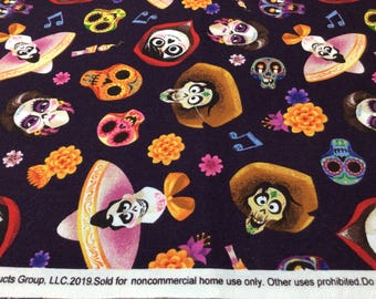 May include: Dark purple fabric with a repeating pattern of Day of the Dead themed illustrations. The design includes sugar skulls, flowers, musical notes, and characters in sombreros. The fabric has a festive and colorful appearance.