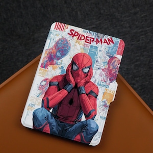 May include: A white tablet case featuring a comic-style illustration of Spider-Man. The design includes a red and blue Spider-Man figure, the words "Spider-Man" in red, and various comic book elements.