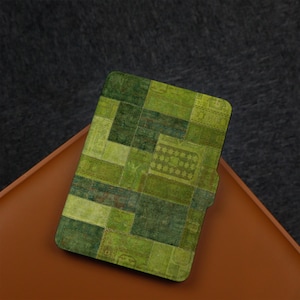 May include: An e-reader case with a patchwork design in shades of green and brown.