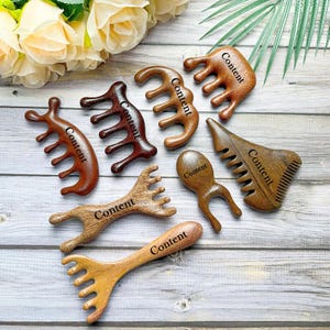 May include: Set of seven wooden massage tools with different shapes and textures. Each tool has the word "Content" engraved on it.