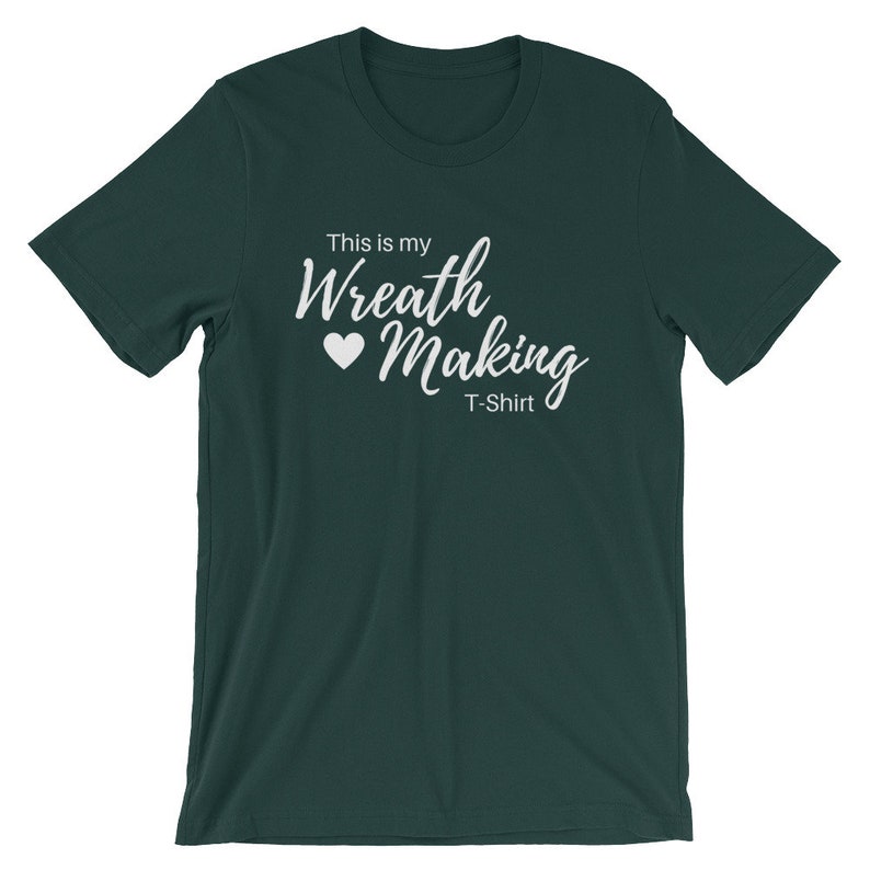 May include: A dark green t-shirt with the text "This is my Wreath Making T-Shirt" in white lettering with a white heart.