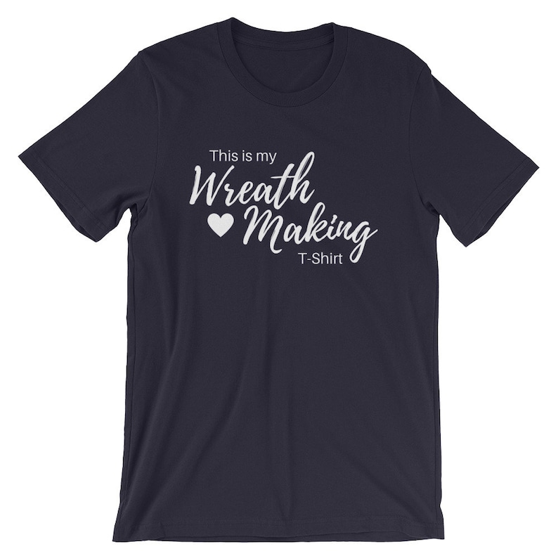 May include: Navy blue t-shirt with white text that reads "This is my Wreath Making T-Shirt" with a white heart symbol.