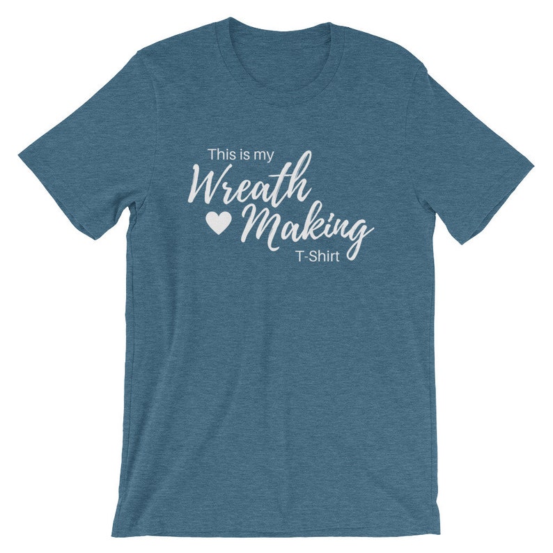 May include: A teal blue t-shirt with the text "This is my Wreath Making T-Shirt" in white lettering with a white heart.