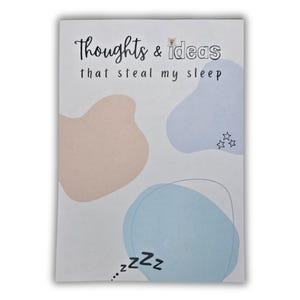 May include: A white card with a light blue, pink, and light blue abstract design. The card has the text "Thoughts & ideas that steal my sleep" and a small drawing of a flower. The bottom of the card has the text "...zzz" with three z's.