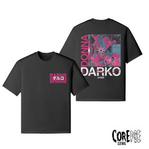 May include: Two black t-shirts with front and back designs. The front of one shirt has the word "DARKO" in pink with Japanese characters. The back of the other shirt features the word "DONNA" and "DARKO" with an abstract pink and blue design.