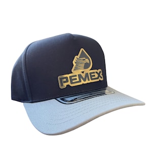 May include: A black and grey baseball cap with a gold logo that says "PEMEX" and a stylized oil drop with a bird inside.