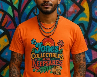 May include: Orange t-shirt with the text "Jones Collectibles and Keepsakes" in a colorful design. The person in the image has tattoos on their arms and is wearing necklaces. The background is a colorful mural.