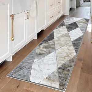 May include: A set of three ceramic mugs with a speckled, matte finish. Each mug features a different color: light blue, cream, and gray. The mugs have a simple, modern design and a comfortable handle.