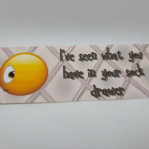 May include: A yellow smiley face with one eye open and the other closed, looking to the left. The text "I've seen what you have in your sock drawer" is written in brown letters on a white and brown patterned background.