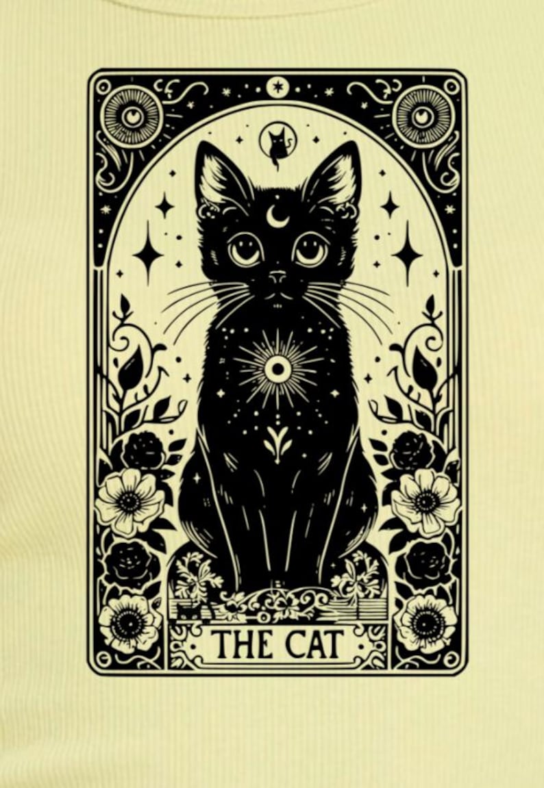 May include: A black and white illustration of a tarot card featuring a black cat with a crescent moon on its forehead. The card is surrounded by a decorative frame with stars and flowers. The text "THE CAT" is printed at the bottom of the card.