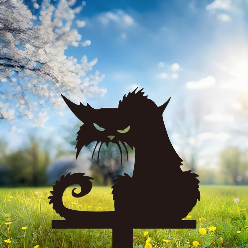 May include: Black metal cat silhouette garden stake with an angry expression. The cat has pointed ears, a curled tail, and a crossbar for easy placement in the yard. The background features a sunny sky and green grass.