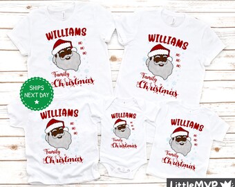 May include: White t-shirts featuring a black Santa Claus graphic and the text "Williams Family Christmas".