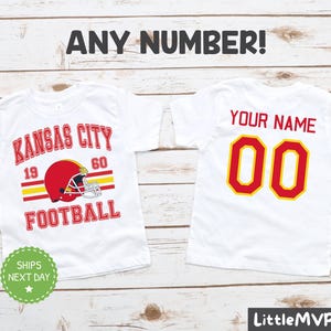two personalized kansas city football shirts on a wooden background