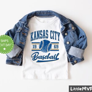 a kansas city baseball t - shirt with a denim jacket