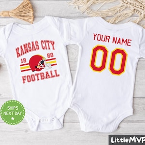 two baby onesuits with a football helmet on them