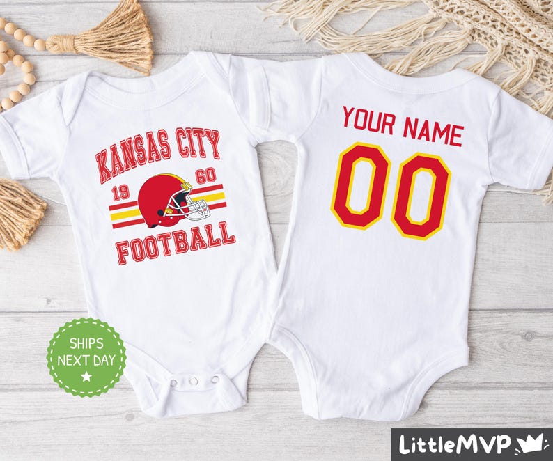 two baby onesuits with a football helmet on them