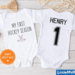 two baby onesuits with hockey numbers on them