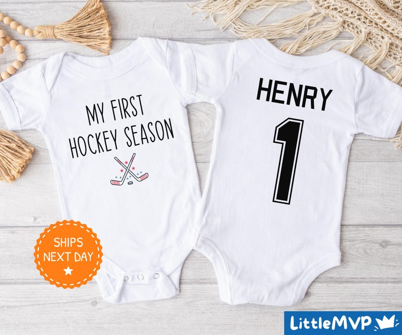 two baby onesuits with hockey numbers on them