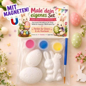 Può includere: Un kit artigianale pasquale con il testo "Male dein eigenes Set". Il kit include vasetti di vernice rosa, blu e gialla, statuette di coniglietti e uova bianche e un pennello. La confezione presenta illustrazioni di coniglietti e uova decorate.