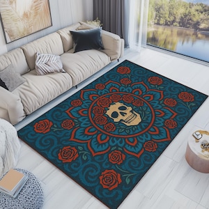 May include: A rectangular area rug with a teal background and a central design featuring a tan skull surrounded by red roses. The rug has a mandala-like pattern with red and teal accents, suitable for a living room.