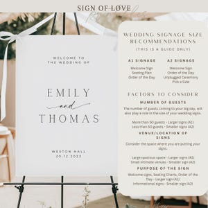 May include: A white wedding welcome sign on a black easel. The sign reads "Welcome to the Wedding of Emily and Thomas" with the date and venue. Additional text provides wedding signage size recommendations.
