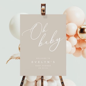 Może przedstawiać: Beżowy znak powitalny z białą kaligrafią, na którym widnieje napis "Oh baby" oraz tekst "Witamy na Baby Shower Evelyn 09.04.24".