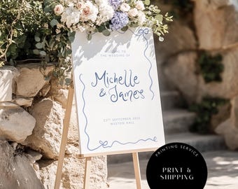 May include: White wedding sign with blue calligraphy announcing the wedding of Michelle & James on September 23, 2025 at Weston Hall.