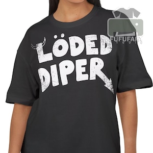 May include: Black t-shirt featuring the white text "LÖDED DİPER" and a downward-pointing arrow. The shirt has short sleeves and a round neck. The text has a distressed, textured appearance.