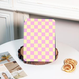 May include: A pink and yellow checkered pattern e-reader cover.