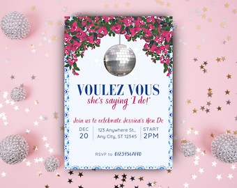 May include: A white invitation with blue and pink accents. The invitation features a disco ball hanging from a floral garland and the text "Voulez Vous she's saying 'I do!'". The invitation also includes the date, time, and location of the event.