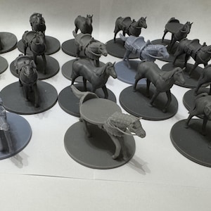 May include: A collection of grey miniature horse figurines, each mounted on a circular base. The horses are depicted in various standing poses, some equipped with saddles or harnesses, rendered in a monochromatic grey finish with smooth surfaces.