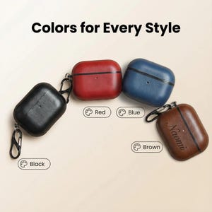Peut inclure: Quatre &eacute;tuis en cuir pour AirPods, noirs, rouges, bleus et marron, chacun avec un mousqueton. L'&eacute;tui marron est personnalis&eacute; avec le nom "Naomi". Le texte "Colors for Every Style" est en haut.