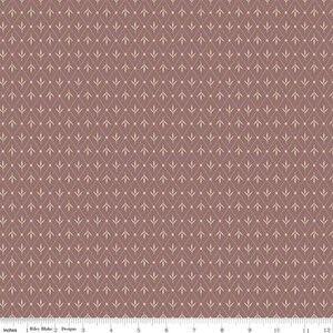 May include: A fabric with a repeating pattern of cream-colored leaf-like shapes and dots on a mauve background. The design is arranged in a diamond grid, creating a textured appearance. The fabric is measured in inches.