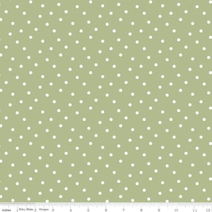 May include: A green fabric with a white polka dot pattern. The fabric is a repeating pattern of white dots on a solid green background.