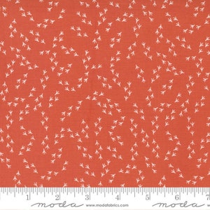 May include: Red fabric with a white chicken track pattern. The fabric is measured in inches.