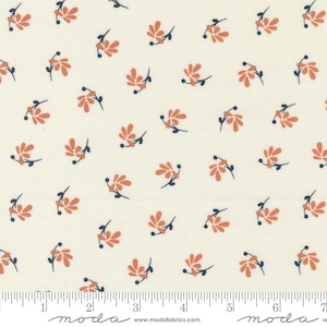 May include: A cream-colored fabric featuring a repeating pattern of small, orange, multi-petaled flowers with dark navy stems and buds. A ruler at the bottom shows measurements in inches, with the text moda www.modafabrics.com printed below.
